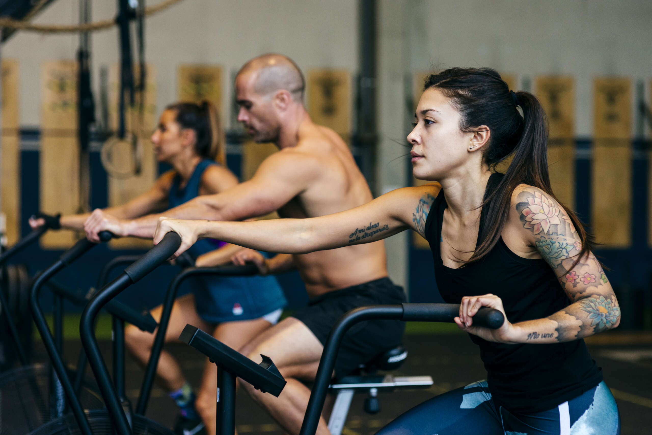 group of men and women on stationary bike at gargoyle strength and fitness in auburn wa