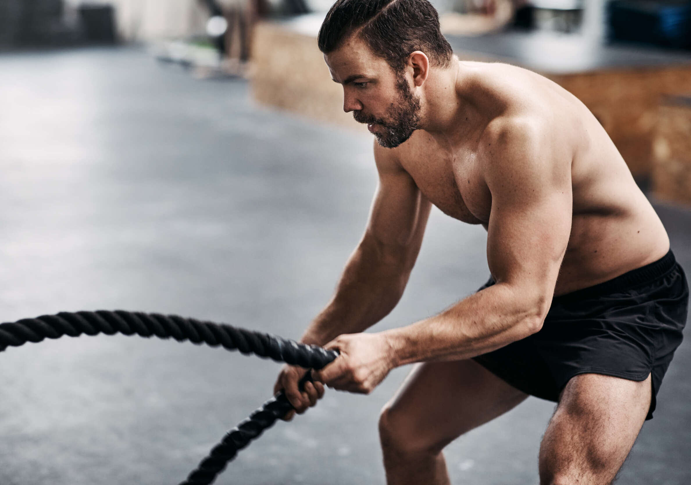 in shape man swinging ropes as excercise at auburn wa gym