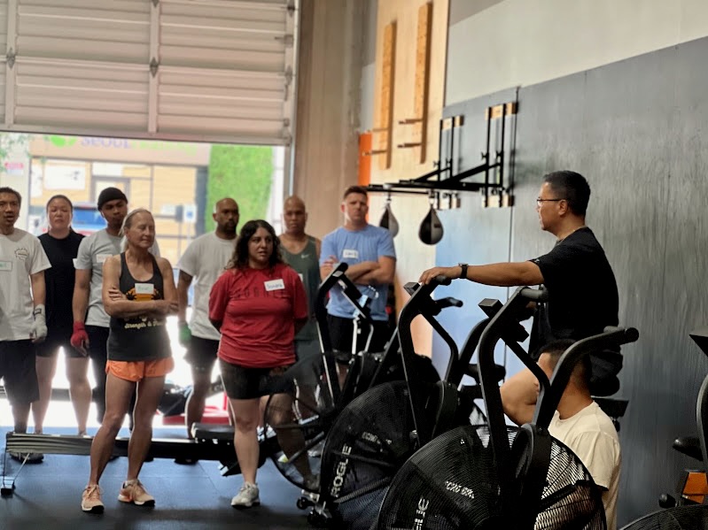 group work out with private trainer instructing group while on stationary bike in auburn wa