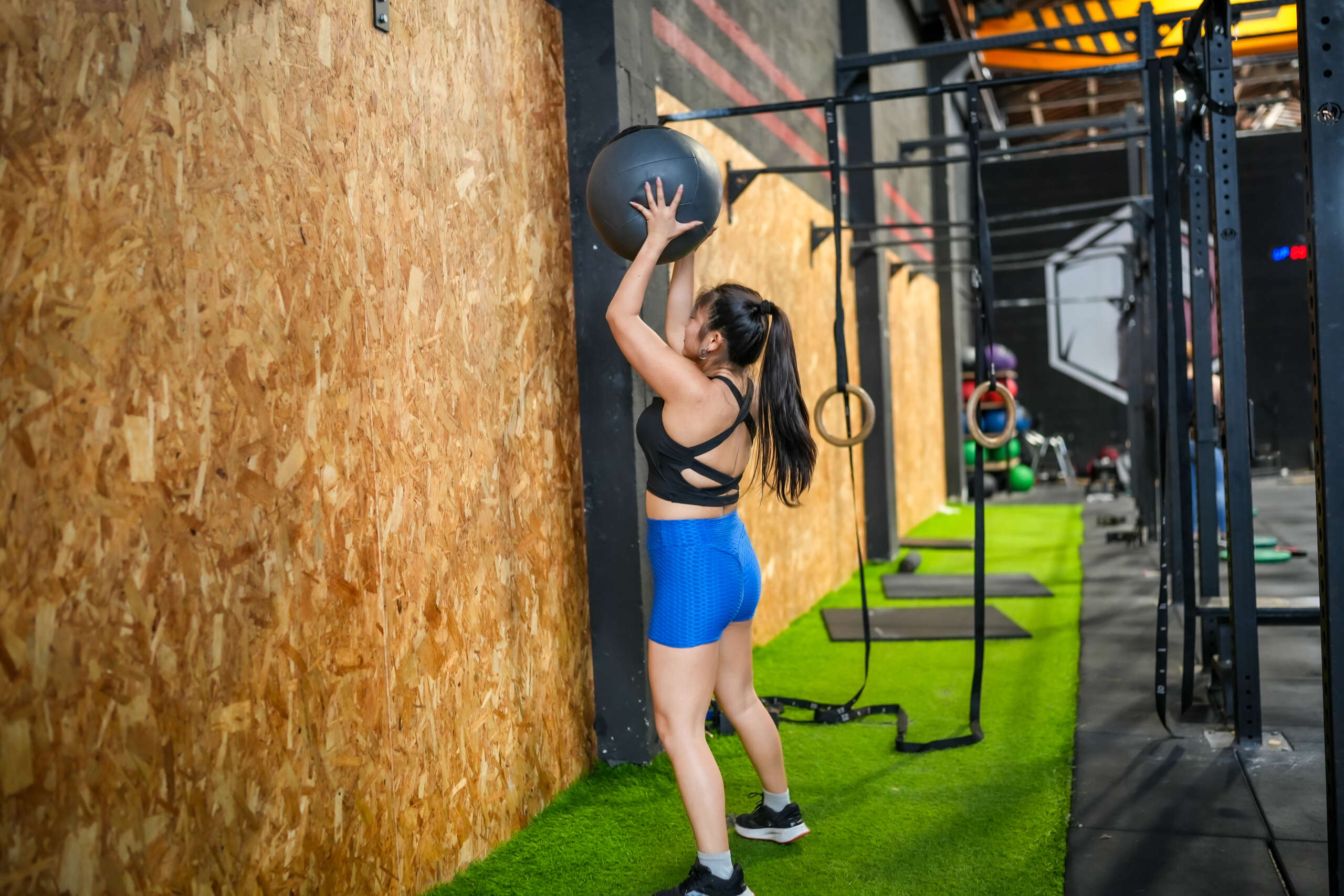 asian woman using excercise ball at gym in auburn wa
