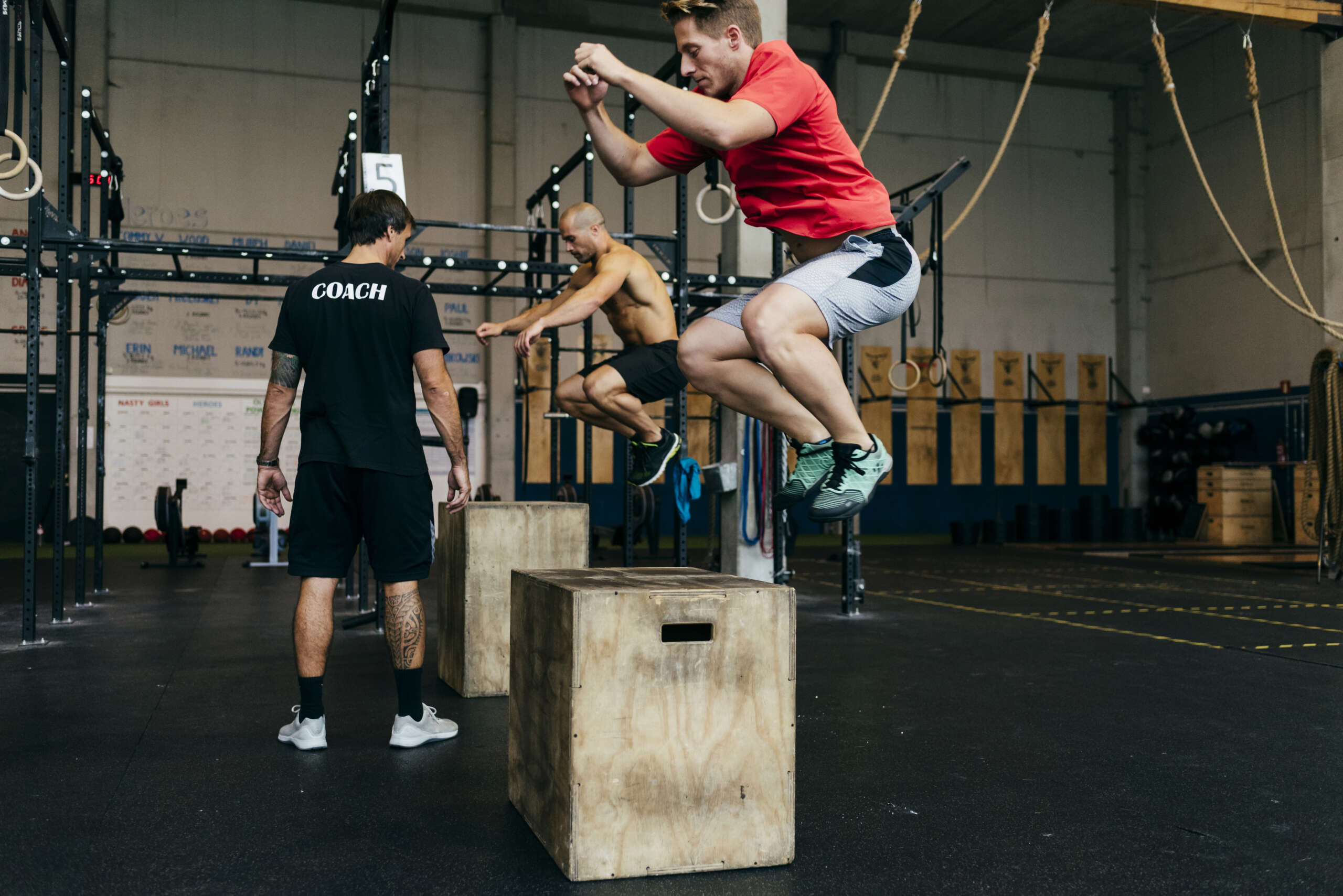 small group fitness class with certified fitness coach with member jumping on wooden boxes in auburn wa
